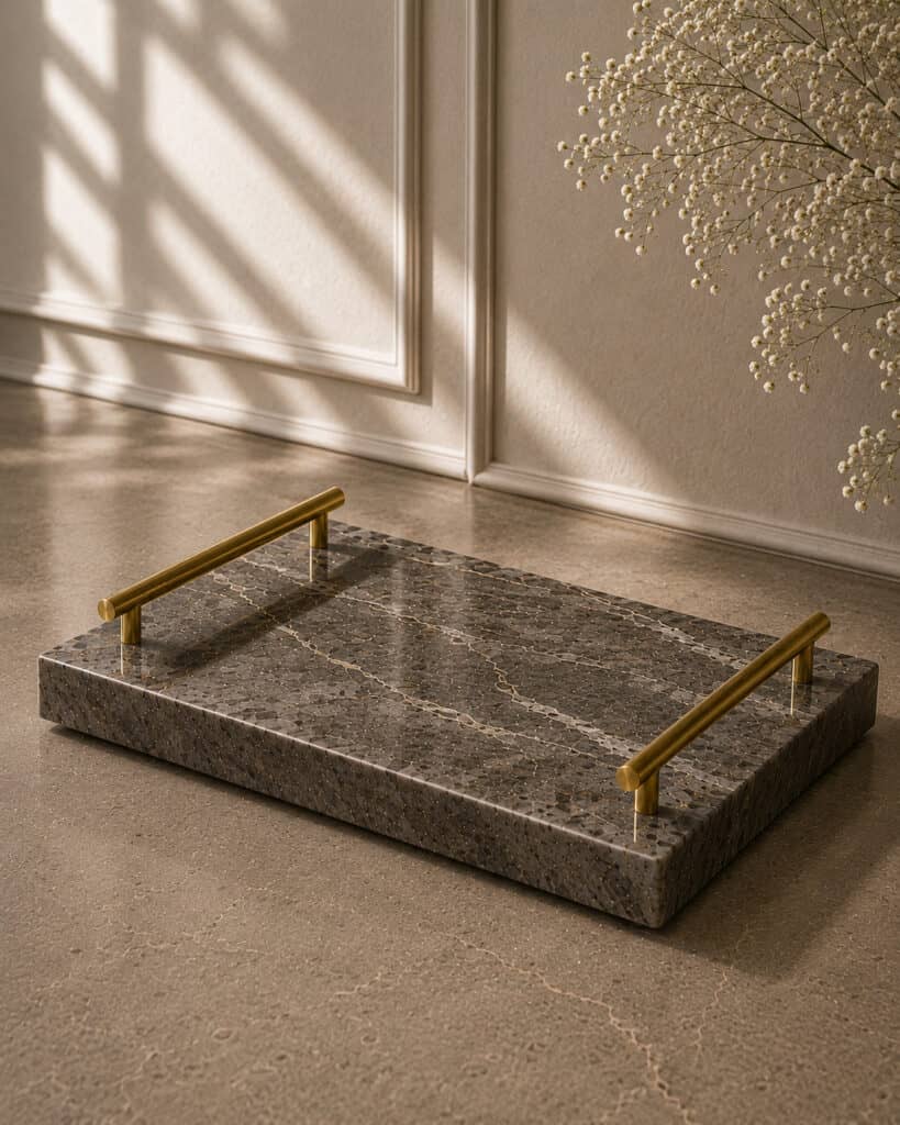 Marble tray with metal handles on a neutral floor, ideal for home decor and organization.